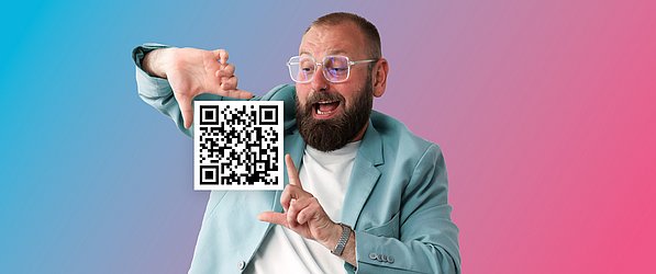 2D-Code mit GS1 Digital Link Symbolbild für 2D.Code mit GS1 Digital Link: Ein junger Mann hält mit einem GS1 QR-Code