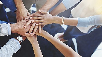 Fotografie Händeschlag/Zusammenhalt/Team zur Mitte