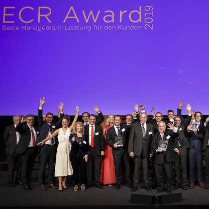 Foto der jubelnden Preisträger des ECR Award 2019 vor lila Hintergrund 